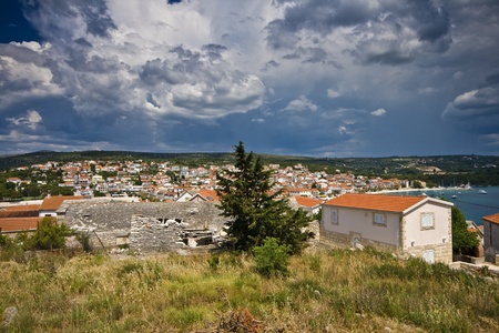 Panorama of Primosten with the rainy clouds in the summer skyの写真素材
