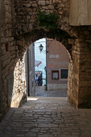Arch and stonepaved alley by the coast in Rovinjのeditorial素材