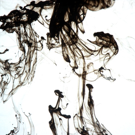 Black ink drops in the waterの写真素材