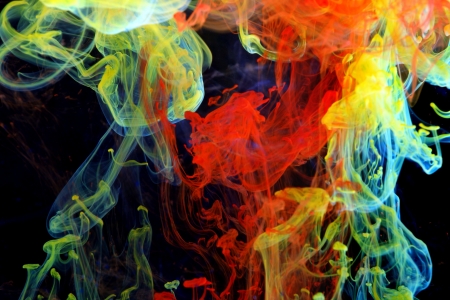 Blue, red and yellow ink in the waterの写真素材