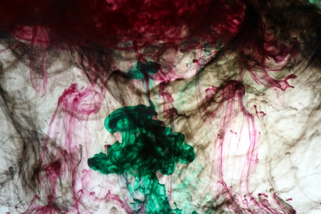 Green, black and red ink in the waterの写真素材