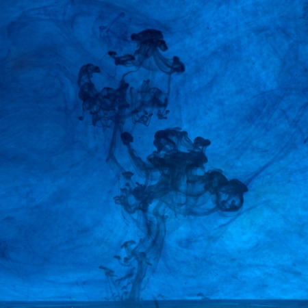 Red and blue ink in the waterの写真素材