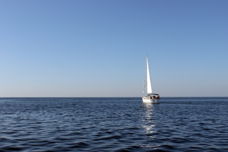 White sailboat on the blue sea 