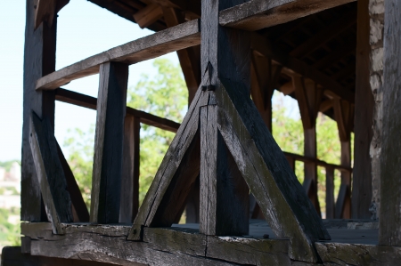 Old wooden balcony on the wall of the fortress, big thick logsの写真素材