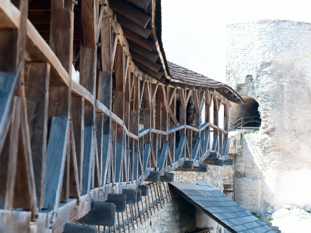 Old wooden balcony on the wall of the fortress, big thick logsの写真素材