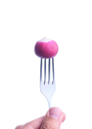 radish on a fork isolated on whiteの写真素材