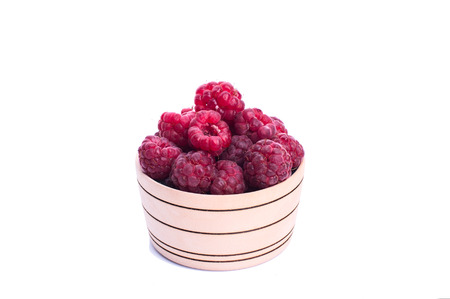 raspberries in a basket and empty space for your text