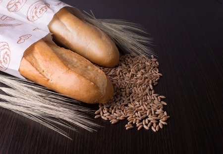 fresh bread  and wheat on the wooden, spikelets of wheat