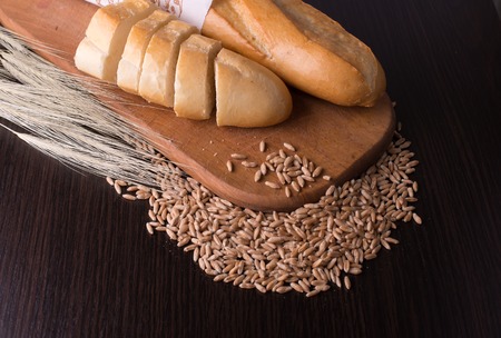 fresh bread  and wheat on the wooden, spikelets of wheat