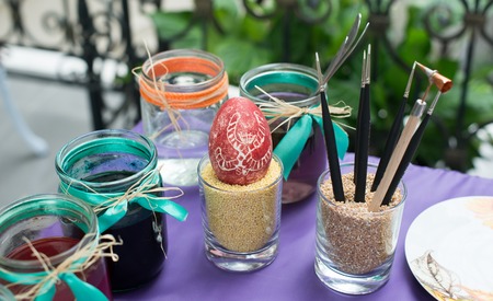 Colorful paints on palette with brushes ready for painting easter eggs. Concept for art and craft...