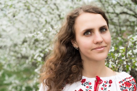 portrait of young lovely woman in spring flowers