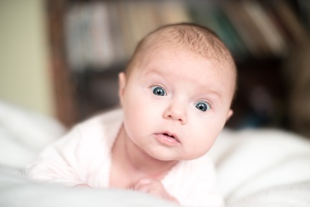 Surprised baby isolated on whiteの写真素材