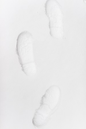 Human footprints in the snow under sunlight close-up viewの写真素材