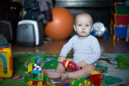 Portrait of boy drinking glass of water  in the nurseryの写真素材