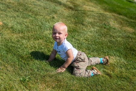 Portrait of a young boy lying in the grassの写真素材