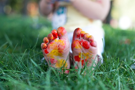 Couple lying on green grass. Children having fun outdoors in spring parkの写真素材