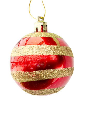 Brightly red with a gold ornament a New Year's sphere on the white isolated backgroundの写真素材