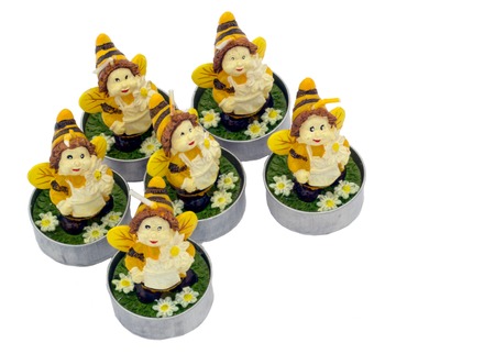 Decorative candles in the form of bees on the white isolated background.の写真素材