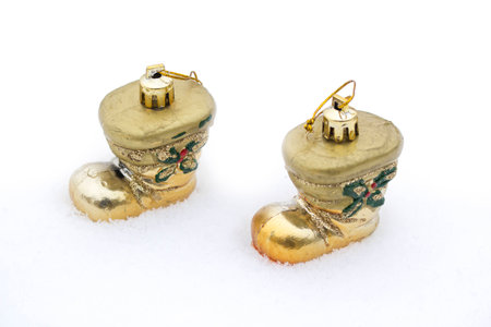 Christmas gold boots on white snow. Christmas and new year come nearerの写真素材