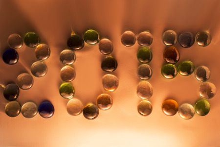 Inscription two thousand fifteen multi-coloured beads on a golden backgroundの写真素材