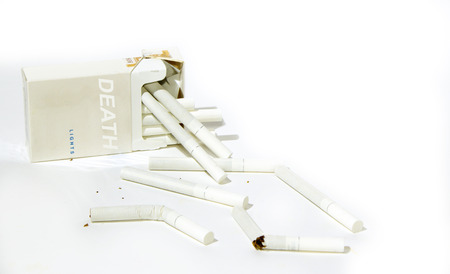 Pack of cigarettes with an inscription death and the broken cigarettes on the white isolated backgroundの写真素材