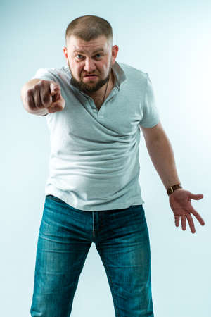The evil bearded man is very unhappy with something. He points his index finger at the viewer.の写真素材