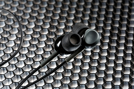 Black stereo headphones with metal comb close upの写真素材
