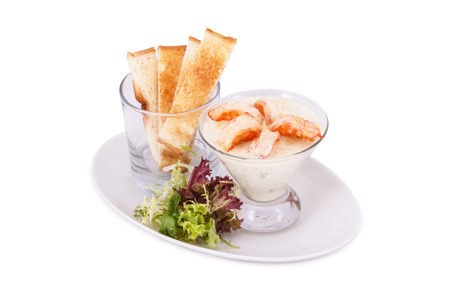 A prawn cocktail in a glass, with salad and rusk on white backgroundの写真素材