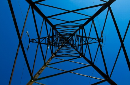 Pylon power lines against blue sky の写真素材