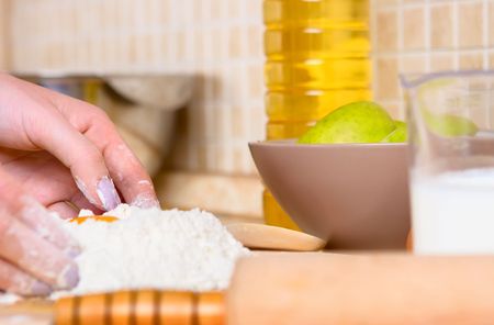 Young woman making apple cake 