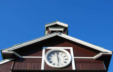 Roman numerals clock on old wooden chapel の写真素材