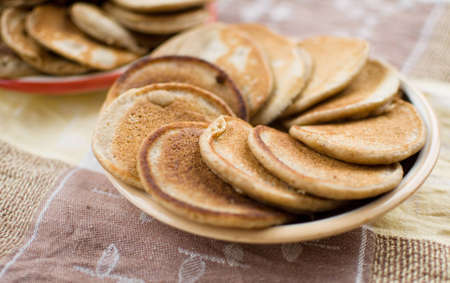 stack of sweet oat pancakes on ceramic plateの写真素材