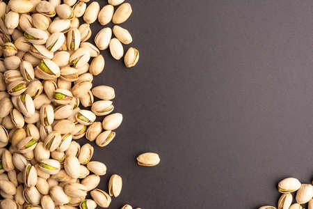 Isolated pistachio on black background top view. Planeの写真素材
