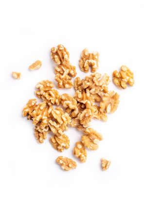 Peeled walnuts on a white background. Top view. Plane.