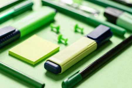 Stationery (for school or office) on a colored background. Selective focus.