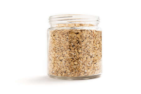 Front view of a jar of oat flakes isolated on white backgroundの写真素材