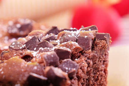 Close-up of chocolate cake with glass sugar plated with beige backgroundの写真素材