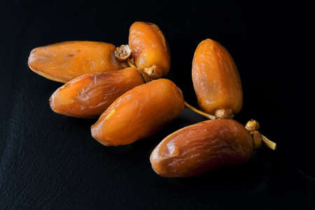 Macro of dates on branch on black backgroundの写真素材