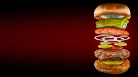 Open burger floating with mustard pickle bread and ketchup red and black background in 16: 9 formatの写真素材
