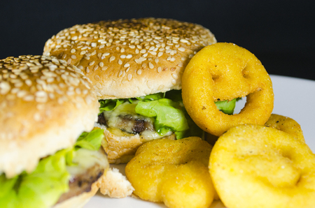 Delicious hamburger with sesame bread and french fries smileの写真素材