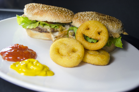 Delicious hamburger with sesame bread and french fries smileの写真素材