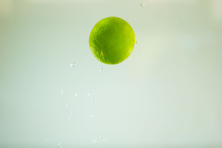 Lemon plunging into waterの写真素材