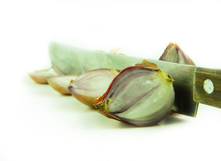 Onions with knife on white backgroundの写真素材