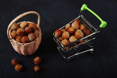 Hazelnuts, filbert in burlap sack on wooden backdrop. heap or stack of hazelnuts. Hazelnut background, healty foodの写真素材
