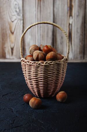 Hazelnuts, filbert in burlap sack on wooden backdrop. heap or stack of hazelnuts. Hazelnut background, healty foodの写真素材
