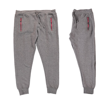 Pants folded in half. Warm gray pants with red zippers. Isolated image on a white background. Nobody.の写真素材