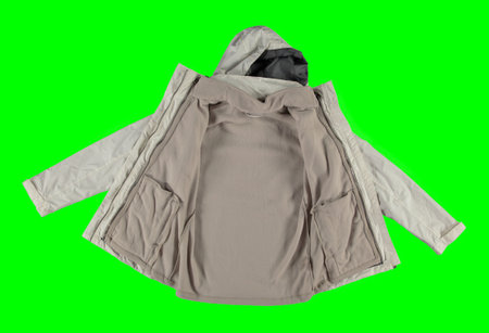 Open white warm jacket. Isolated white women's jacket on a green background. Isolated image on a green background. Nobody.の写真素材