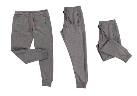 Pants folded in half. Warm gray pants with red, blue zippers. Isolated image on a white background. Nobody.の写真素材