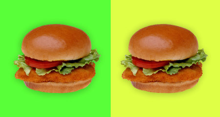 Burger with chicken cutlet, tomato and lettuce. Yellow-green background. Bun without cheese.の写真素材