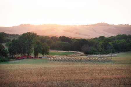 Photo of a farm in tuscany at the sunset time
